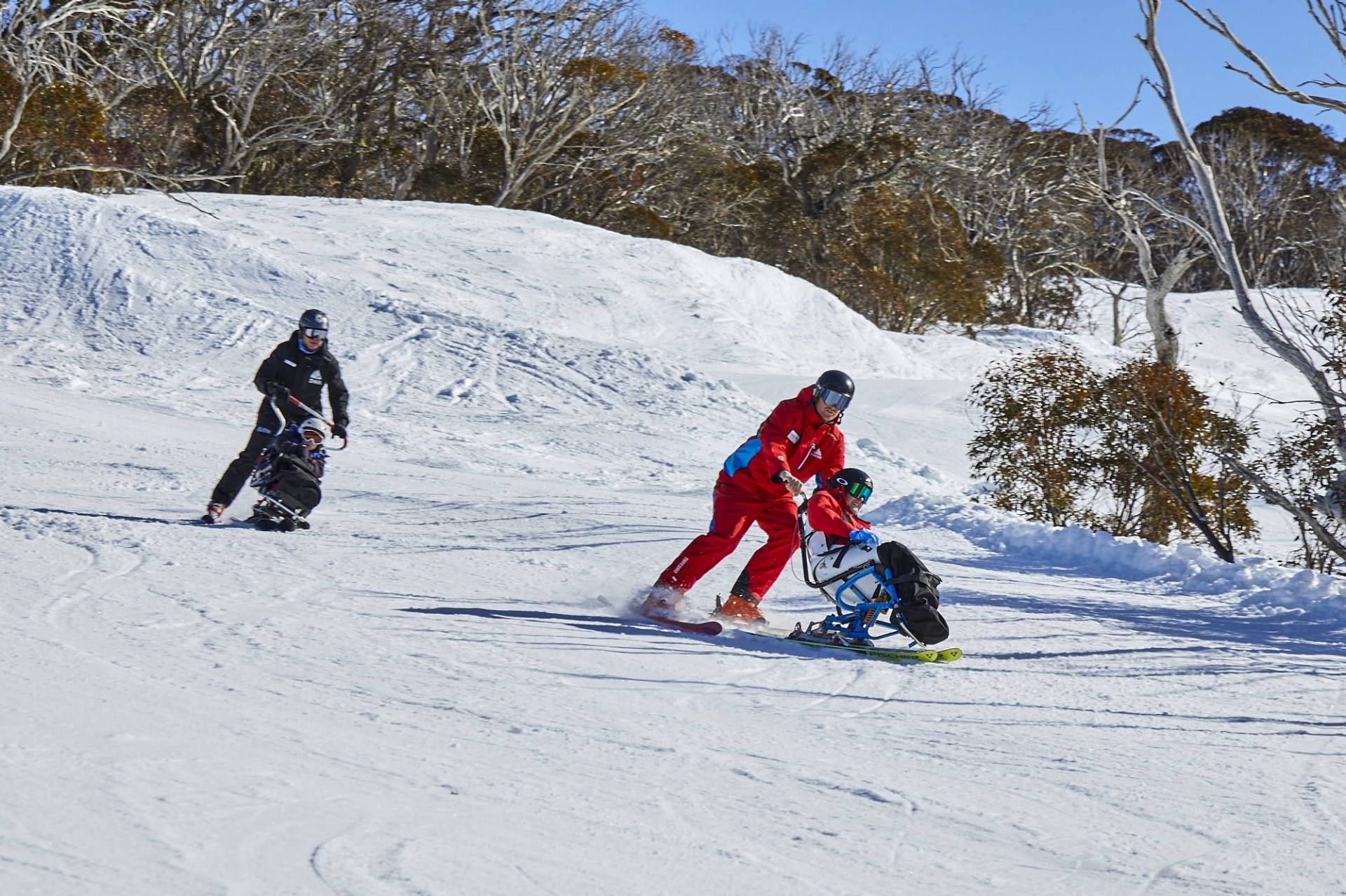 Adaptive skiing down the mountain at Thredbo Alpine Village, Snowy Mountains, New South Wales © Tourism Australia