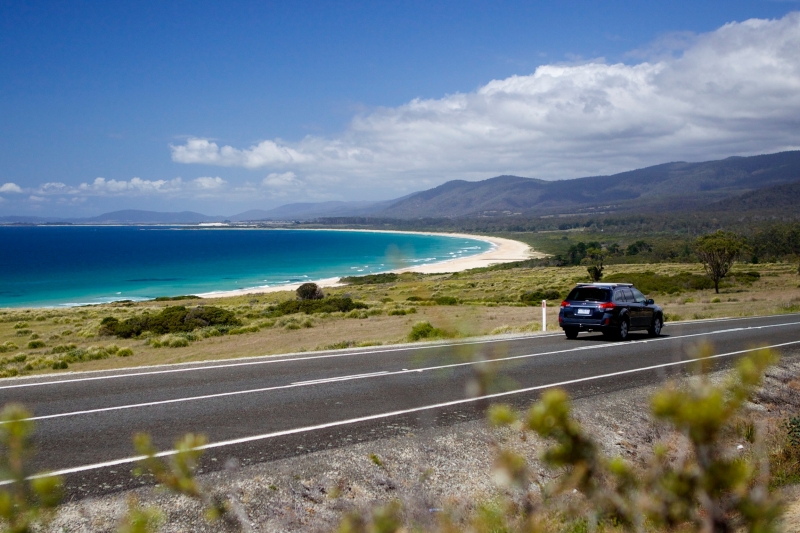 Car driving on road next to the ocean in Lagoons Beach Conservation Area © Pete Harmsen/Tourism Tasmania Car driving on road next to the ocean in Lagoons Beach Conservation Area © Pete Harmsen/Tourism Tasmania