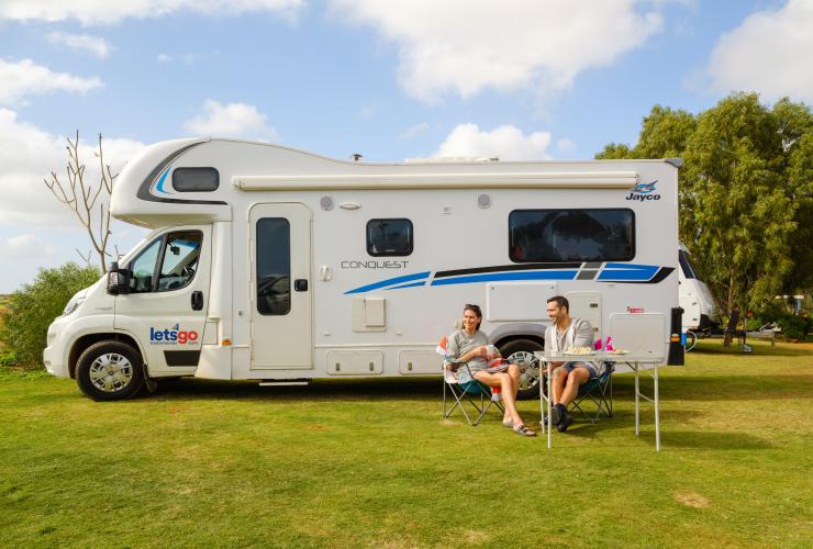 Couple relaxing near their motor-home at the Big River Ranch in Kalbarri © Tourism Western Australia