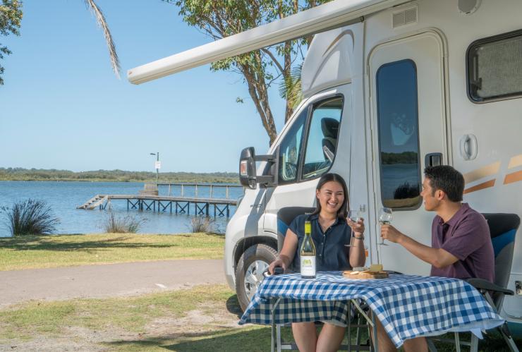 Couple enjoying a glass of wine and water views from their campervan in BIG4 Koala Shores Port Stephens Holiday Park © Destination NSW Couple enjoying a glass of wine and water views from their campervan in BIG4 Koala Shores Port Stephens Holiday Park © Destination NSW