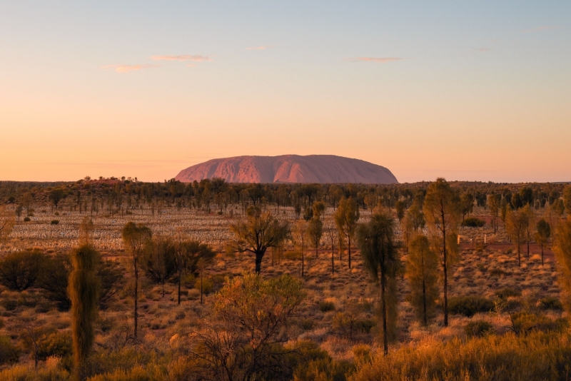 A large red rock monolith rising from the flat outback landscape at Uluru, Uluru-Kata Tjuta National Park, Northern Territory © Tourism Australia A large red rock monolith rising from the flat outback landscape at Uluru, Uluru-Kata Tjuta National Park, Northern Territory © Tourism Australia