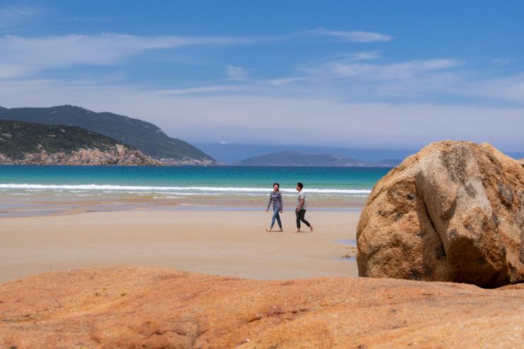 Couple strolling across Norman Beach © Visit Victoria