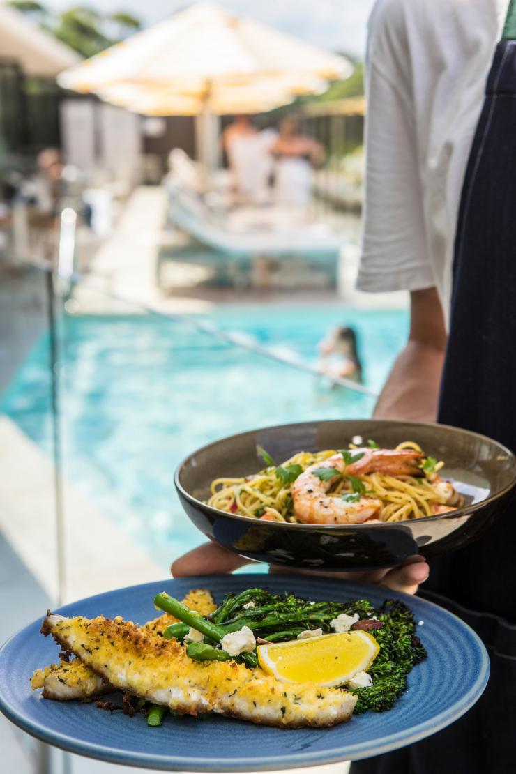 Plates of seafood at Bannisters by the Sea Restaurant © Destination NSW