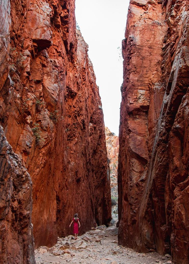 Woman walking near gap, Standley Chasm, West MacDonnell Ranges, NT © Tourism Australia