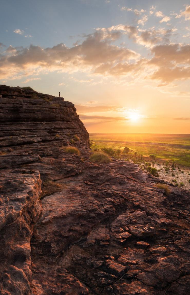 Man standing on the top of the rock in Ubirr, Kakadu National Park © Tourism NT/Daniel Tran9
