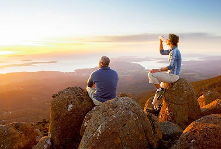 Couple enjoys sweeping views from the top of Mt Wellington © Tourism Tasmania / Glenn Gibson