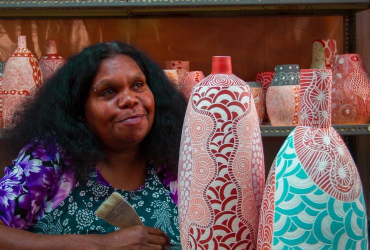 An Aboriginal artist seated beside ceramic artworks at Ernabella Art, Longitude 131, Uluru, Northern Territory © Longitude 131 An Aboriginal artist seated beside ceramic artworks at Ernabella Art, Longitude 131, Uluru, Northern Territory © Longitude 131