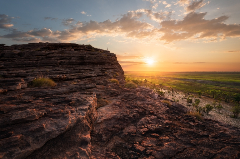 Man standing on the top of the rock in Ubirr, Kakadu National Park © Tourism NT/Daniel Tran