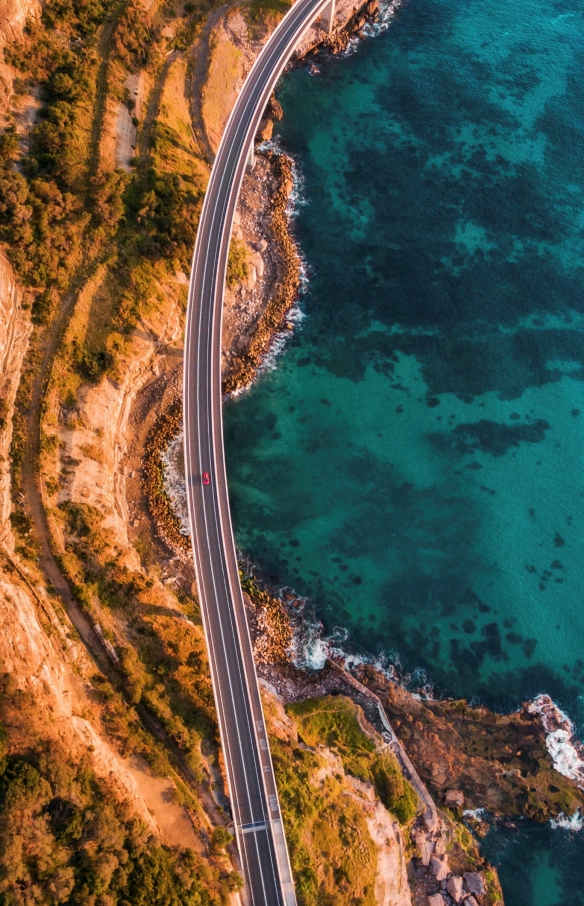 Aerial view of the Sea Cliff Bridge suspended over the ocean in Clifton, New South Wales ©  Destination NSW