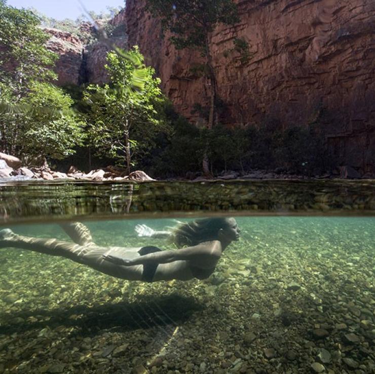 A woman swimming in a waterhole in El Questro Wilderness Park in The Kimberley © Tourism Western Australia A woman swimming in a waterhole in El Questro Wilderness Park in The Kimberley © Tourism Western Australia