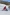 Two people with limited mobility adaptive skiing with instructors down a snow-covered mountain in Thredbo, Snowy Mountains, New South Wales © Tourism Australia