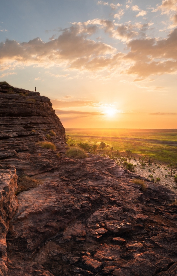 Man standing on the top of the rock in Ubirr, Kakadu National Park © Tourism NT/Daniel Tran