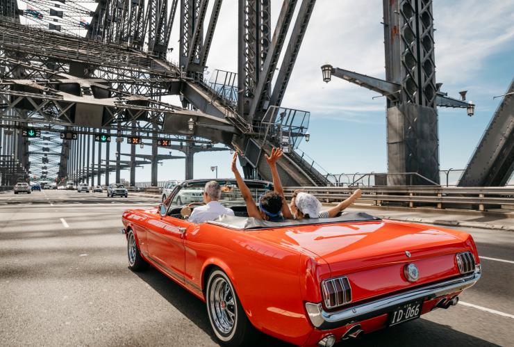 Friends being chauffeured over the Sydney Harbour Bridge with Sydney Mustang Wedding Cars, Sydney, NSW © Destination NSW Friends being chauffeured over the Sydney Harbour Bridge with Sydney Mustang Wedding Cars, Sydney, NSW © Destination NSW