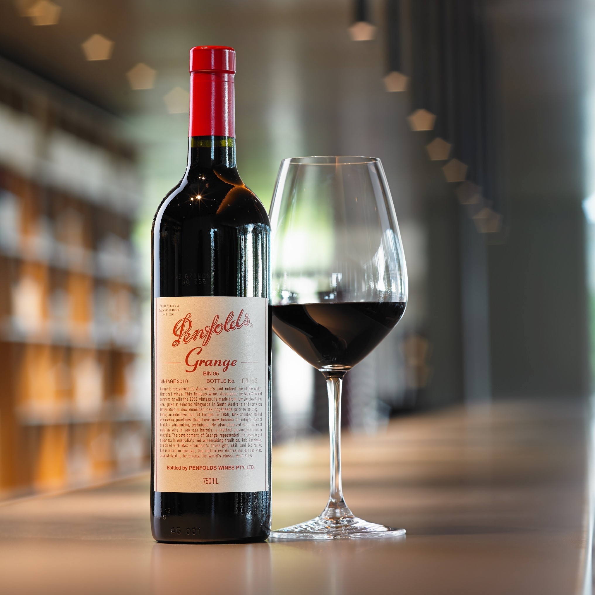 A bottle and glass of Penfolds Grange wine © Penfolds