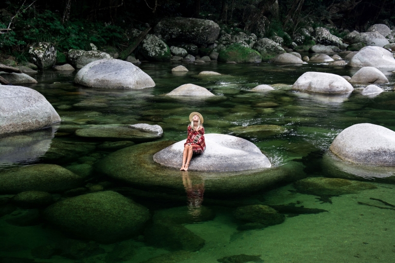 Woman sitting on a boulder in Mossman Gorge in the Daintree National Park © Luxury Lodges of Australia