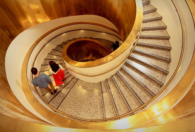 A gold winding staircase at the WA Museum Boola Bardip in Perth, Western Australia © Tourism Western Australia