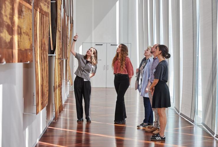 A group of people admiring art with a tour guide at the Art Gallery of New South Wales, Sydney, New South Wales © Art Gallery of New South Wales