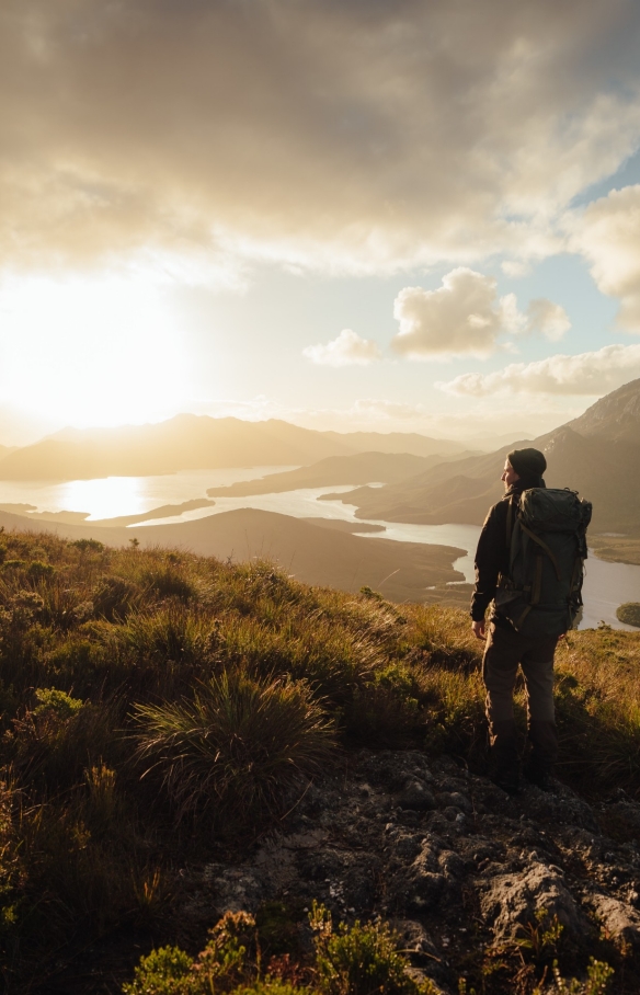 Hiker exploring Bathurst Harbour in Southwest National Park © Jason Charles Hill