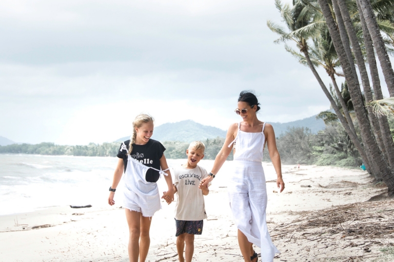 Family walking on the beach at Palm Cove © Tourism and Events Queensland