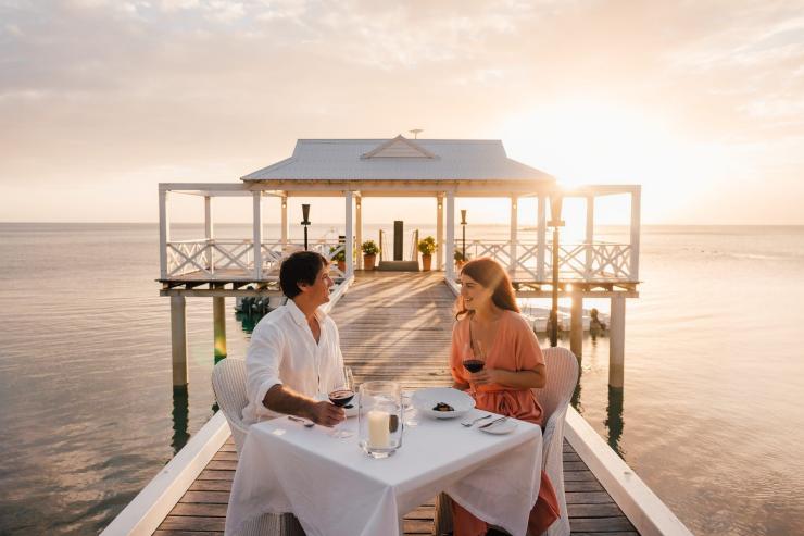 A couple dining on a pier at sunset at Orpheus Island Lodge, Great Barrier Reef, Queensland © Tourism and Events Queensland A couple dining on a pier at sunset at Orpheus Island Lodge, Great Barrier Reef, Queensland © Tourism and Events Queensland