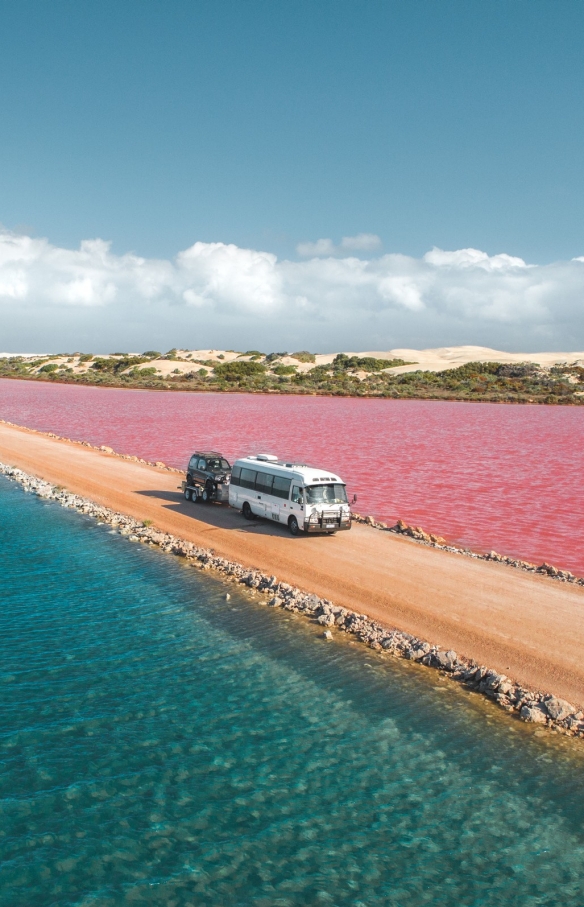 Van driving on a dirt road between pink Lake MacDonnell and Green Lake in the Eyre Peninsula, South Australia © Jaxon Foale