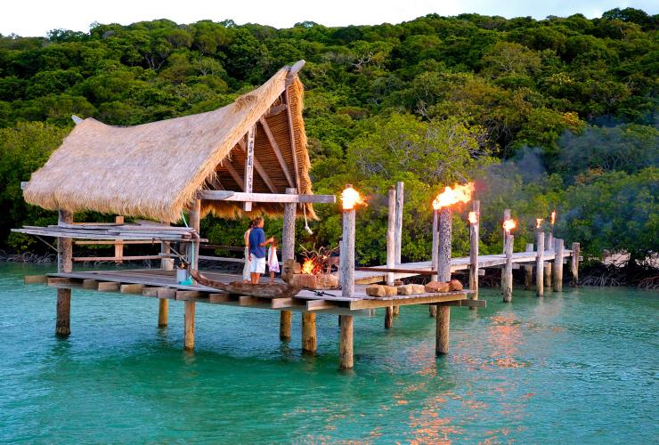 A cabana at the end of a wooden pier over the ocean, lit up with lanterns on Haggerstone Island, Great Barrier Reef, Queensland © Haggerstone Island