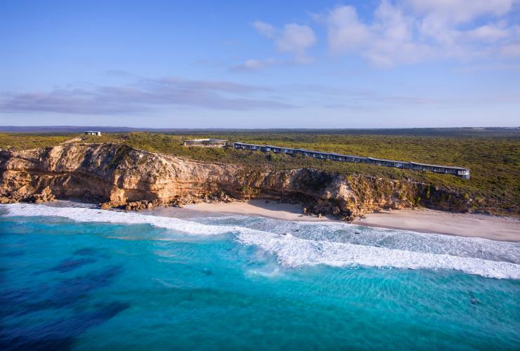 Overlooking the ocean towards a rugged, cliff-lined coast with a string of buildings perched on top at Southern Ocean Lodge, Kangaroo Island, South Australia © Baillie Lodges