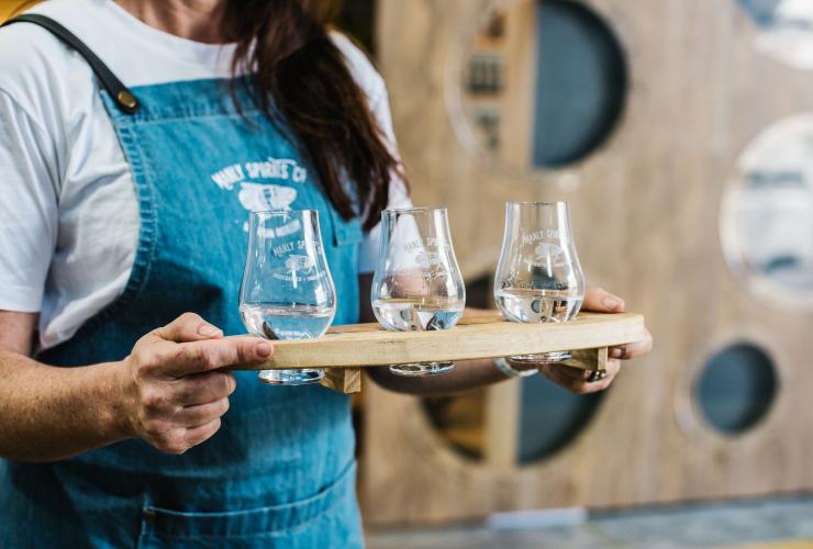 Close up of a bartender holding a tasting paddle of three different spirits at Manly Spirits Co., Manly, New South Wales © Alana Dimou