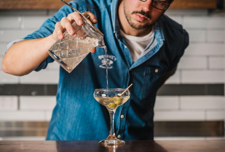 Close up of a bartender preparing a martini with olives at Manly Spirits Co., Manly, New South Wales © Alana Dimou