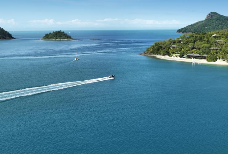 Boat approaching the white sand and greenery surrounding qualia, Hamilton Island, Queensland © qualia
