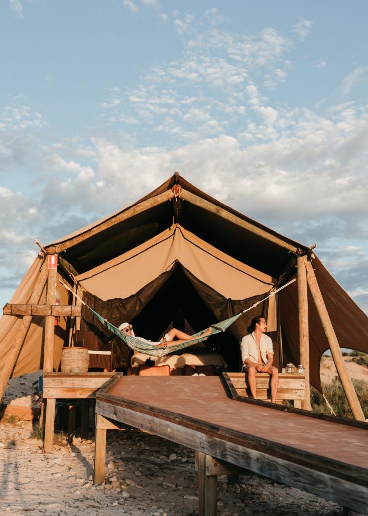 Couple relaxing on the hammock and balcony of their Sal Salis luxury tent, Ningaloo Reef, Western Australia © Sal Salis Ningaloo Reef