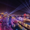 Aerial view over a harbour city adorned in rainbow lights during Vivid Sydney, Sydney, New South Wales © Destination NSW