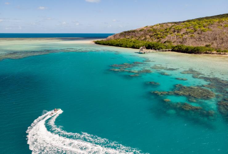 An aerial view of a jetski creating a white wake behind it near Haggerstone Island, Great Barrier Reef, Queensland © Tourism and Events Queensland