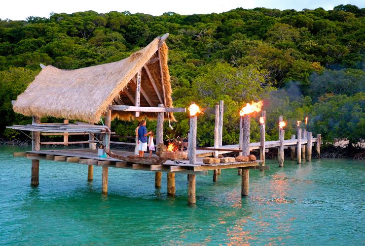 A cabana at the end of a wooden pier over the ocean, lit up with lanterns on Haggerstone Island, Great Barrier Reef, Queensland © Haggerstone Island