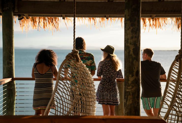 A group of people standing on a balcony overlooking the ocean on Pumpkin Island, Southern Great Barrier Reef, Queensland © Tourism and Events Queensland