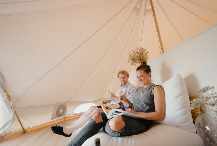 Couple inside tent at Cubby and Co, Majura, ACT © Tourism Australia