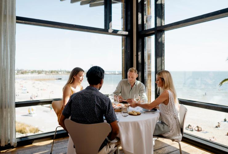 Friends dining in the corner table at Stokehouse, Melbourne, Victoria © Stokehouse
