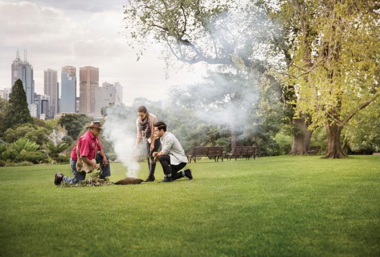 Aboriginal tour guide leads couple on a Heritage Walk in the Royal Botanic Gardens, VIC © Visit Victoria