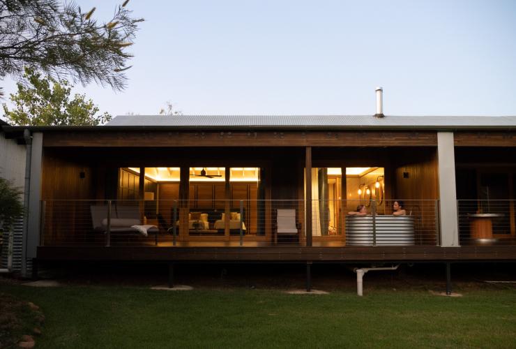 Couple relaxing in an outdoor bath in their outback accommodation at Mt Mulligan Lodge, Mt Mulligan, Queensland © Tourism and Events Queensland