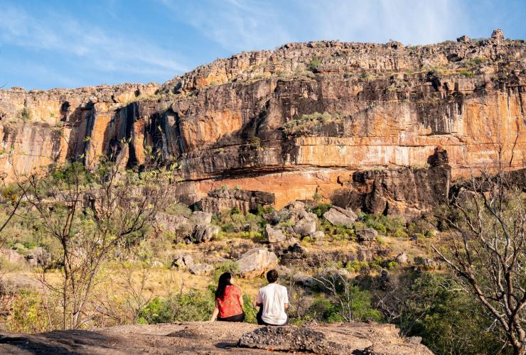 Two friends sitting admiring the rugged rocky landscape of Kakadu National Park near Mercure Kakadu Crocodile Hotel, Kakadu, Northern Territory © Tourism NT/Kane Chenoweth