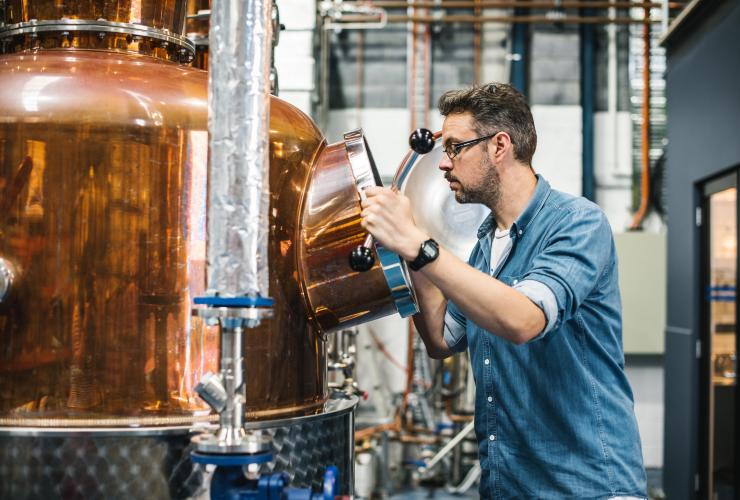 Staff member assessing the progress of distilling liquors at Manly Spirits Co., Manly, New South Wales © Alana Dimou